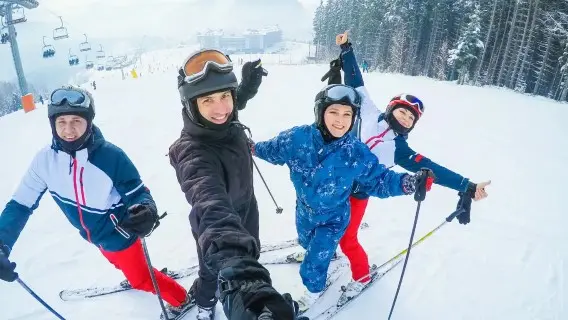 group of people on skis taking a selfie